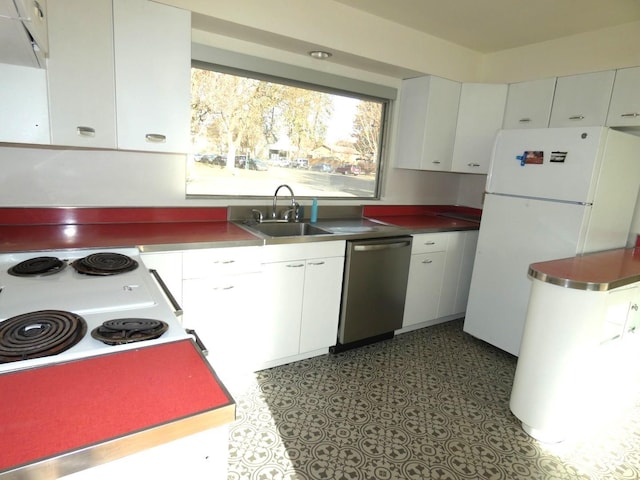 kitchen featuring white refrigerator, dishwasher, sink, and white cabinets