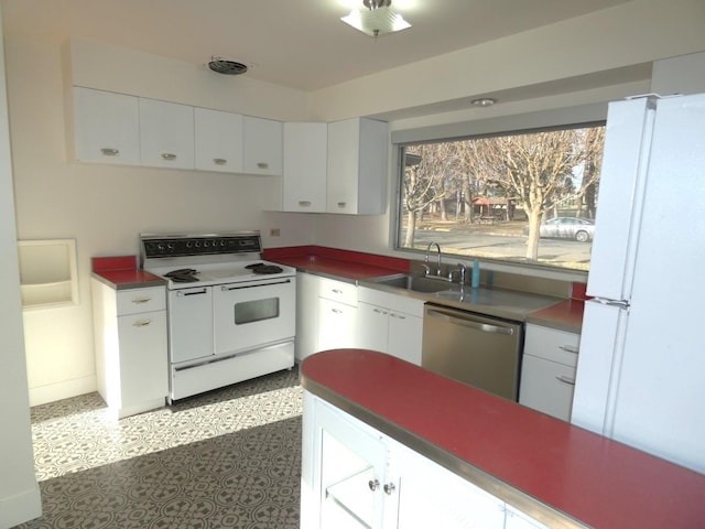 kitchen with white cabinetry, sink, and white appliances