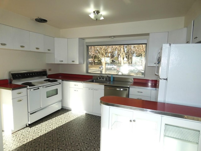 kitchen with sink, white appliances, and white cabinets