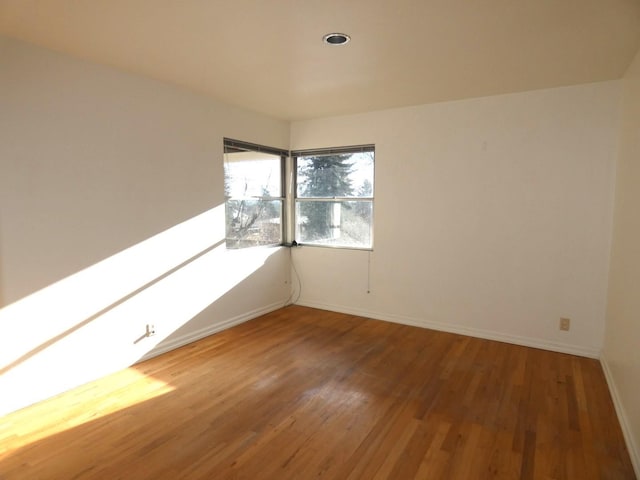 spare room with hardwood / wood-style floors