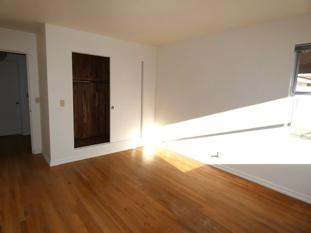 unfurnished bedroom with hardwood / wood-style flooring