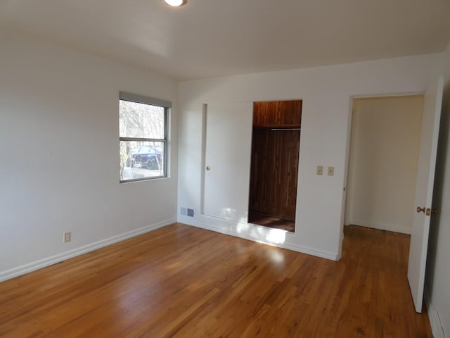 unfurnished bedroom featuring a closet and light wood-type flooring