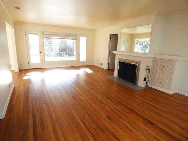 unfurnished living room featuring crown molding and light hardwood / wood-style flooring