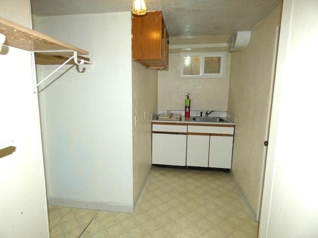 interior space featuring sink and a textured ceiling