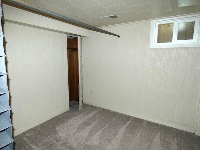 basement featuring carpet floors and ornamental molding