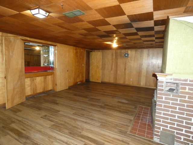 basement with dark hardwood / wood-style floors, wooden walls, and wood ceiling