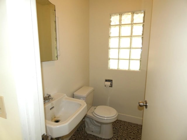 bathroom with tile patterned floors, toilet, and sink