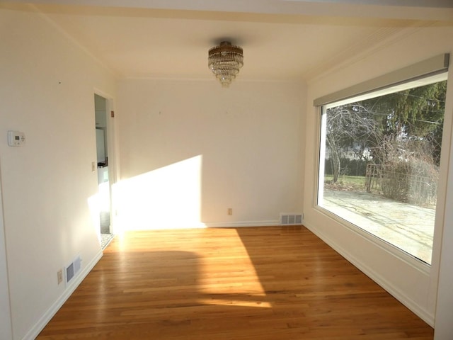 interior space with ornamental molding and wood-type flooring