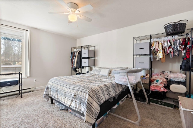 bedroom featuring baseboard heating, ceiling fan, and carpet flooring