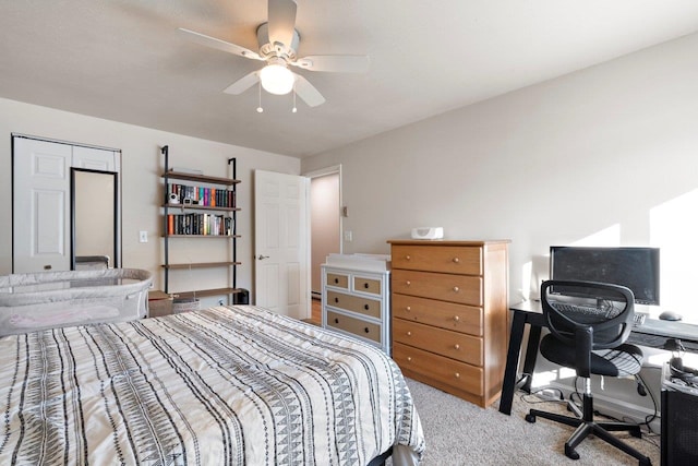 carpeted bedroom with ceiling fan and a closet