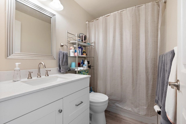 bathroom with a shower with shower curtain, vanity, toilet, and hardwood / wood-style floors