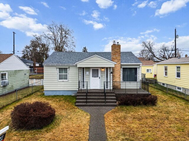 bungalow-style house with a front yard