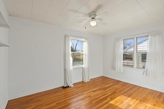 empty room with wood-type flooring and ceiling fan