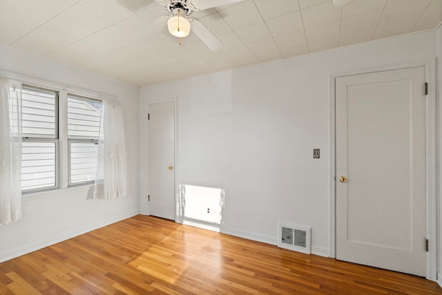 empty room with hardwood / wood-style flooring