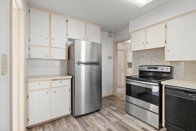 kitchen featuring tasteful backsplash, white cabinetry, appliances with stainless steel finishes, and light wood-type flooring