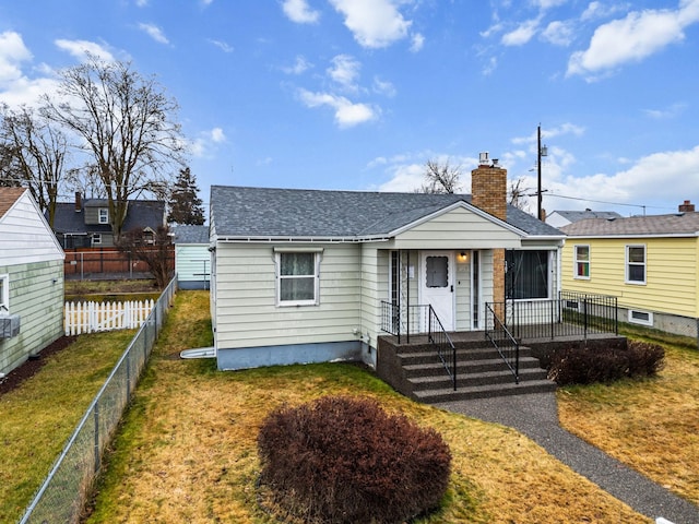 bungalow-style house featuring a front lawn