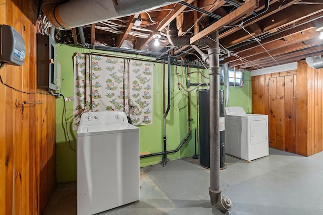 basement with electric water heater and washer and dryer