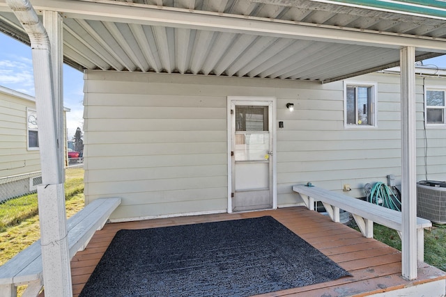 doorway to property featuring a wooden deck and cooling unit