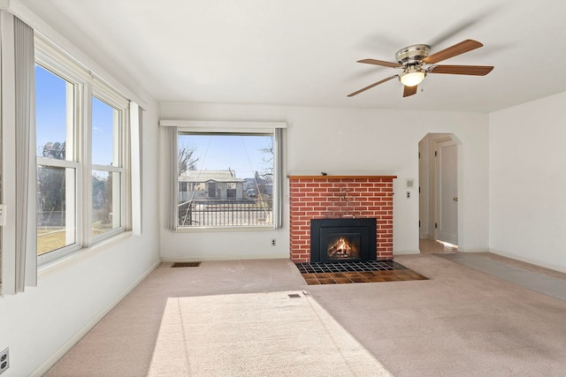 carpeted living room featuring a brick fireplace