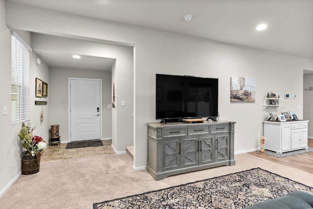 kitchen with stainless steel appliances, under cabinet range hood, dark brown cabinetry, wood finished floors, and light countertops
