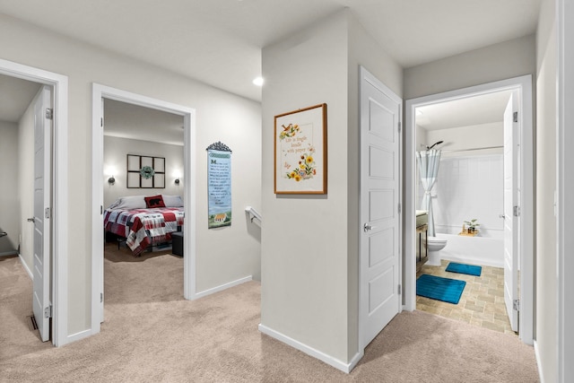 bedroom with light colored carpet and baseboards