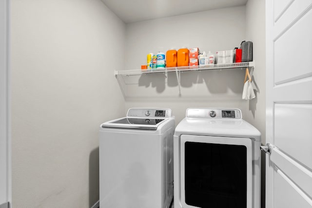 full bath with toilet, stone finish flooring, baseboards, vanity, and a spacious closet