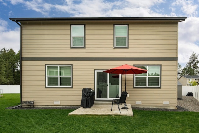 back of property with a yard, a patio area, and a fenced backyard