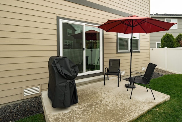view of patio featuring visible vents and fence