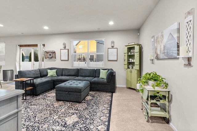 living area with light carpet, baseboards, and recessed lighting