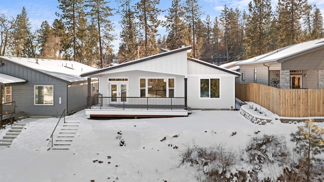 view of snow covered rear of property