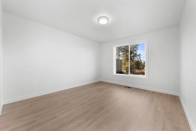 spare room with light hardwood / wood-style flooring