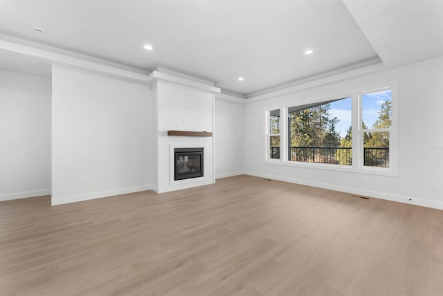 unfurnished living room featuring a fireplace and light hardwood / wood-style flooring