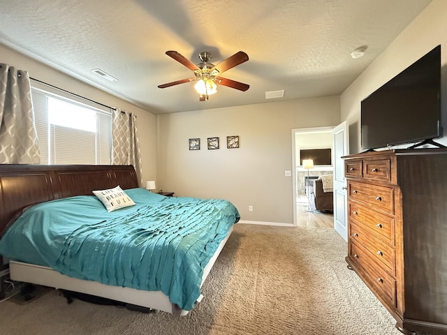 bedroom featuring light carpet, a textured ceiling, and ceiling fan