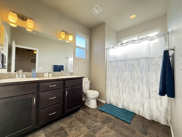 bathroom featuring vanity and toilet