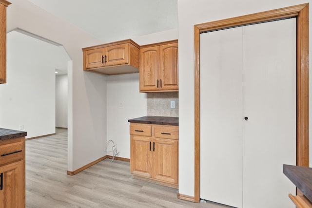 kitchen with tasteful backsplash and light hardwood / wood-style floors