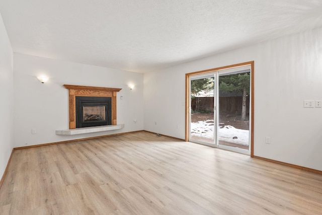 unfurnished living room featuring a fireplace and light hardwood / wood-style flooring