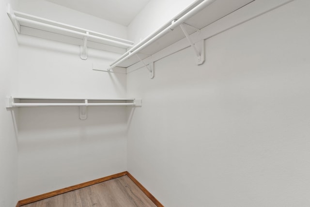 spacious closet featuring hardwood / wood-style floors