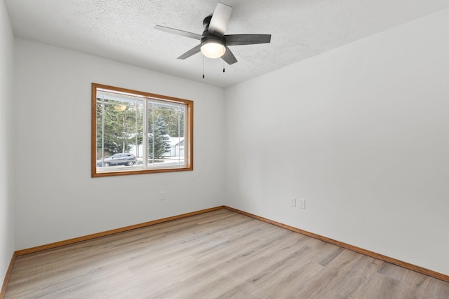 unfurnished room with a textured ceiling, light hardwood / wood-style flooring, and ceiling fan