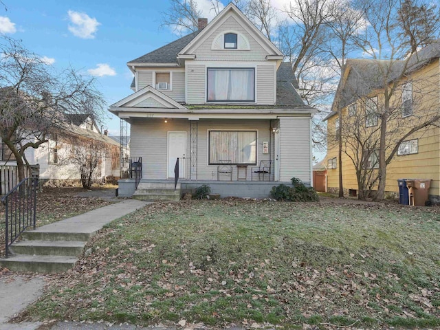 view of front of house featuring covered porch and a front yard