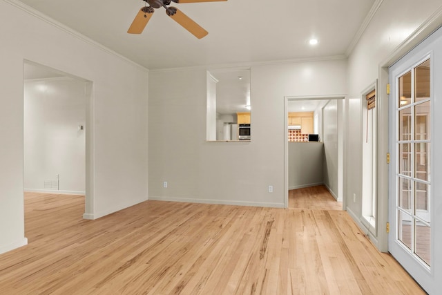 empty room featuring ornamental molding, ceiling fan, and light hardwood / wood-style floors