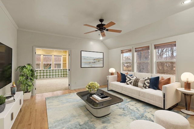 living room featuring ceiling fan, lofted ceiling, ornamental molding, and light hardwood / wood-style flooring