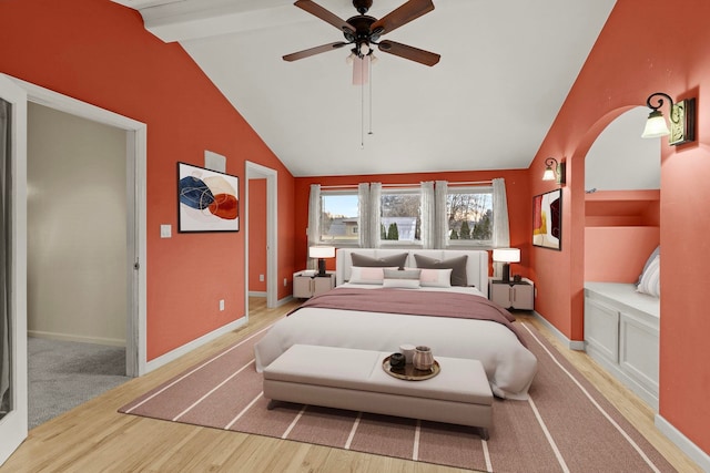 bedroom with vaulted ceiling with beams, hardwood / wood-style flooring, and ceiling fan