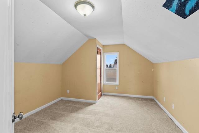 bonus room featuring lofted ceiling and light colored carpet