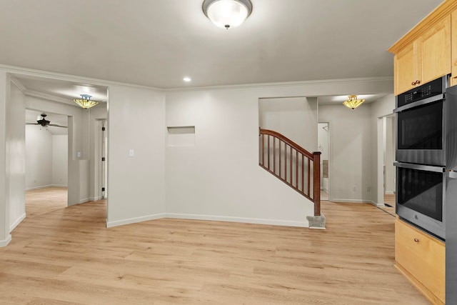 interior space featuring crown molding, ceiling fan, and light wood-type flooring