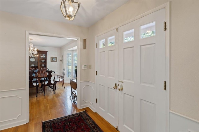 entrance foyer featuring a notable chandelier and light wood-type flooring