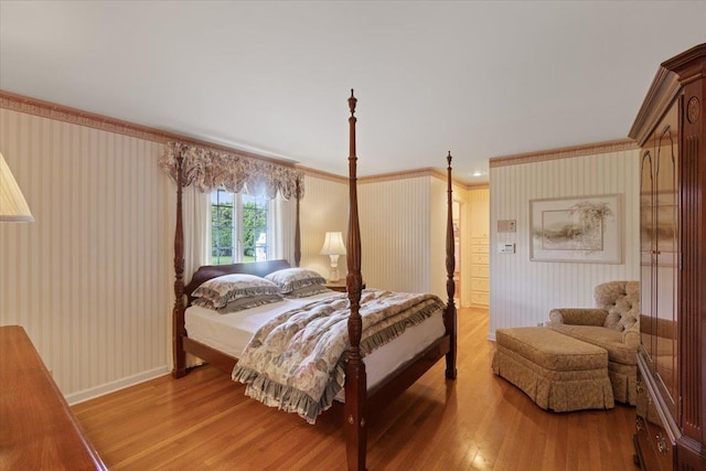 bedroom with crown molding and hardwood / wood-style floors