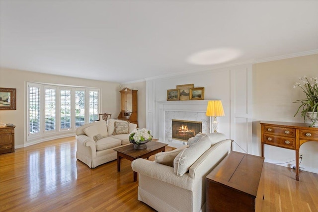 living room featuring ornamental molding and light hardwood / wood-style floors