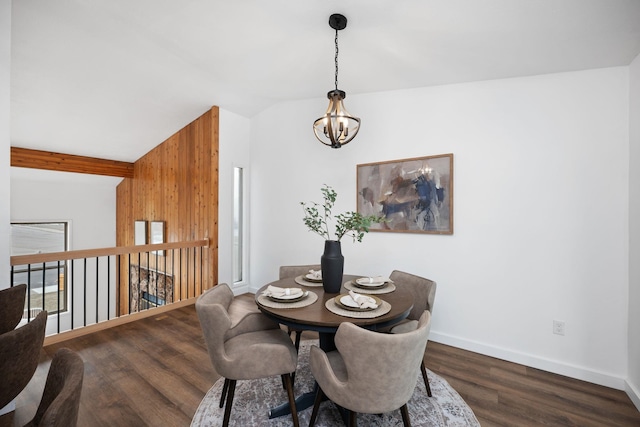 dining space with a notable chandelier, dark wood-type flooring, and lofted ceiling with beams