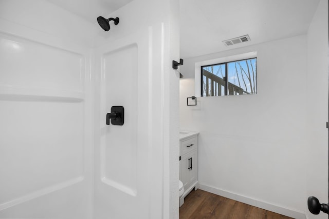 bathroom featuring vanity, hardwood / wood-style flooring, and toilet