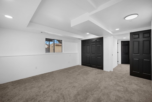 basement featuring light carpet